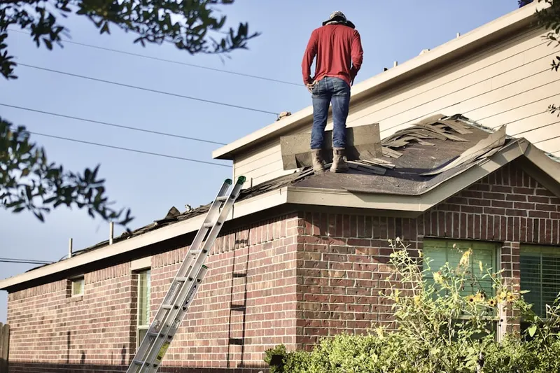 Professional roofer working on a residential roof in Downtown Redmond